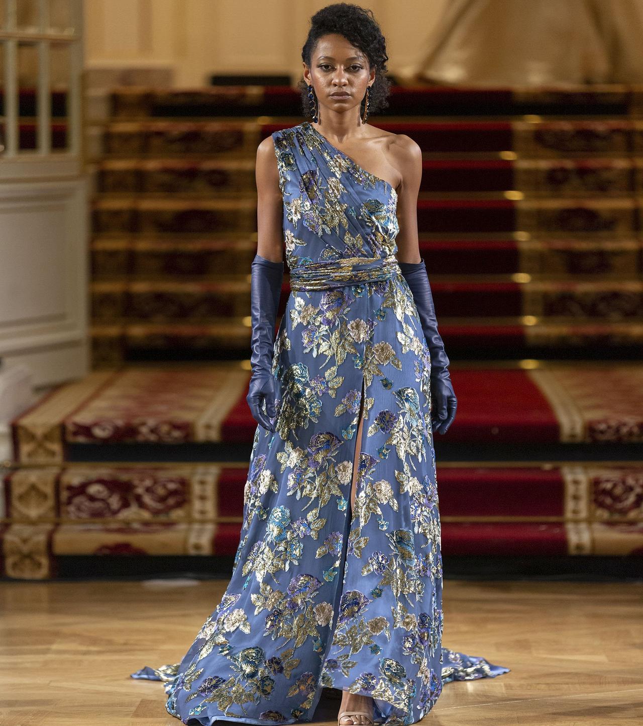 vestido largo azul con estampado de flores doradas con escote asimétrico y abertura en la falda