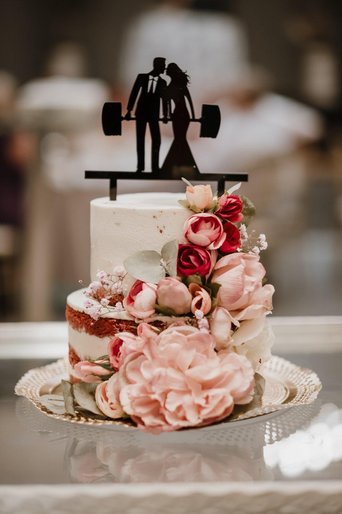 Tarta de boda con grandes flores y figura personalizada