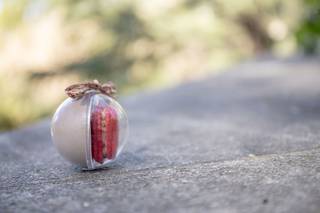 Detalles de boda baratos: macaron rojo en un envase de forma redondeada