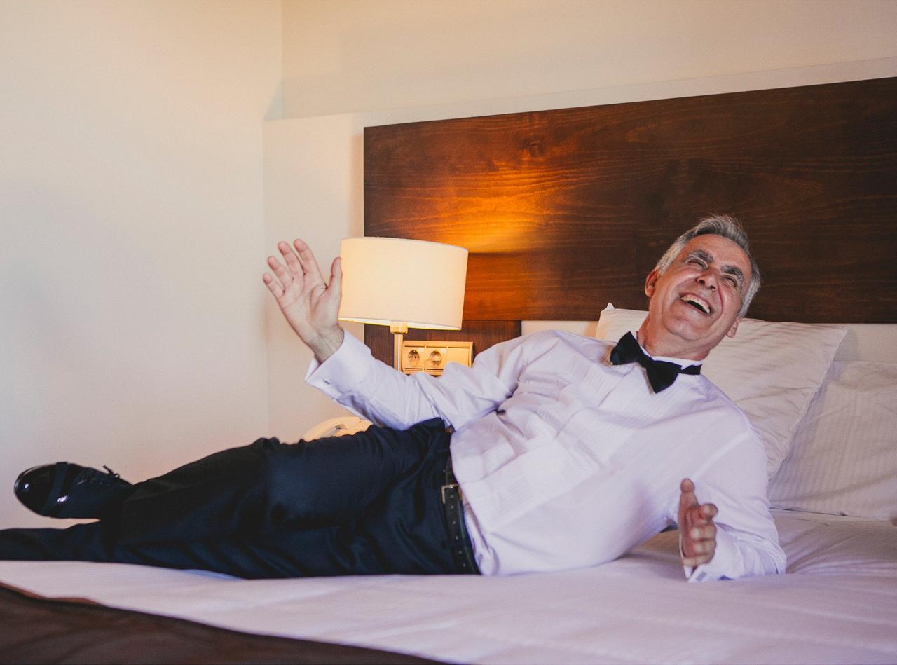 Fotos de padres imprescindibles en la boda: padre del novio feliz en la cama