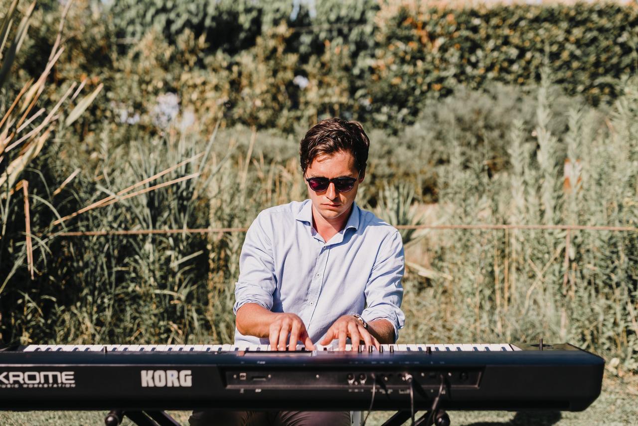 El pianista McRaise tocando un teclado en medio del campo
