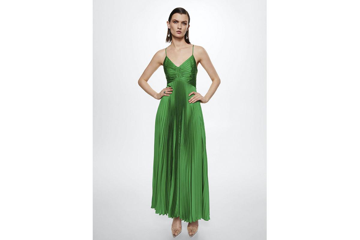 Chica con media melena de efecto wet con un vestido verde con falda plisada y tirantes espagueti