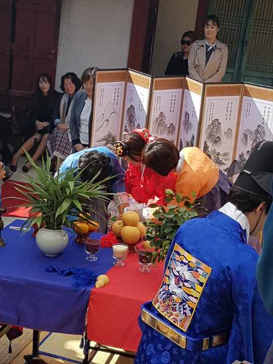 La novia y sus ayudantes y el novio de espaldas en azul