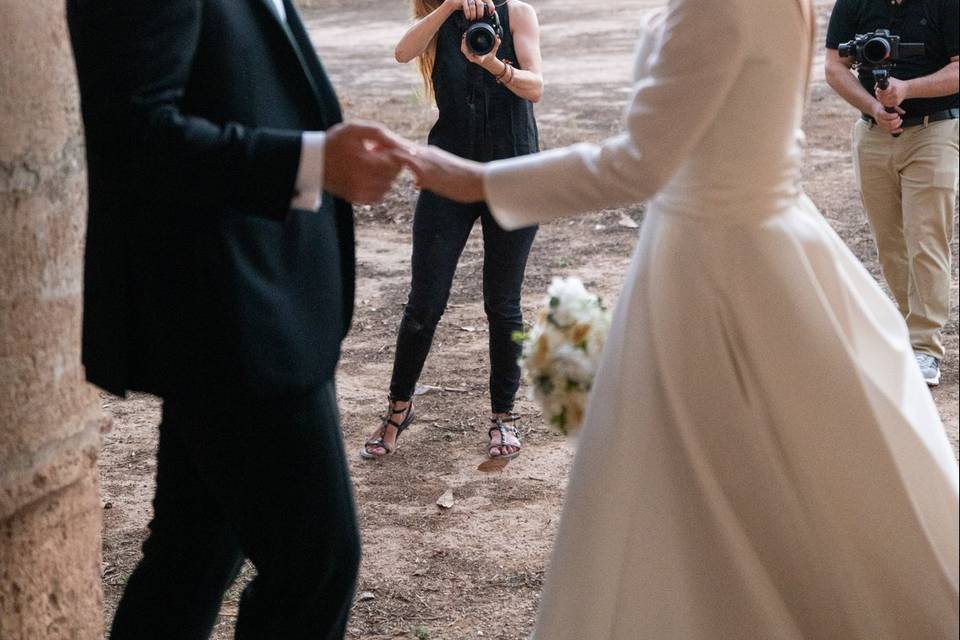Fotógrafa capturando a la pareja caminando por un claustro